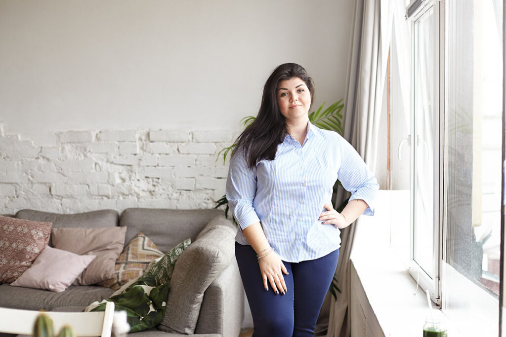 Indoor portrait of overweight plus size young female